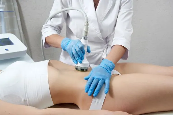 Lost the Weight but Not the Loose Skin? 2 woman having HIFU treatment on her stomach to combat loose skin Hertford following weight loss